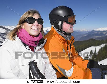 Stock Image - Smiling couple on ski lift. Fotosearch