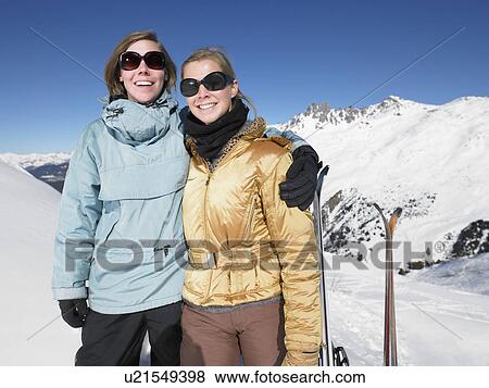 Stock Photo - Smiling young women on mountain top. Fotosearch