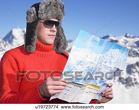 Young man looking at map View Large Photo Image Picture - Young man looking at map. Fotosearch