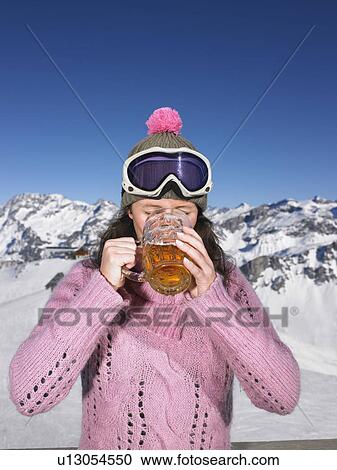 Young woman having drink at mountains View Large Photo Image Stock Image - Young woman having drink at mountains. Fotosearch