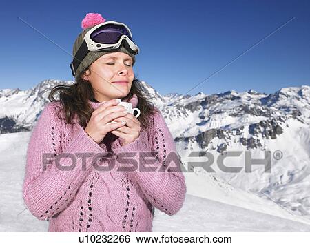 Young woman having drink at mountains View Large Photo Image Stock Photograph - Young woman having drink at mountains. Fotosearch