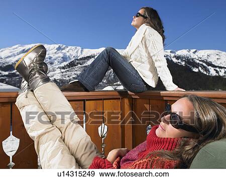 Stock Photo - Young women enjoying sun at mountains. Fotosearch