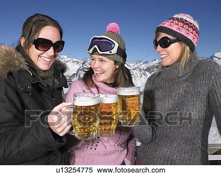 Stock Photography - Young women having drink at mountains. Fotosearch