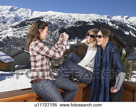 Stock Photography - Young women taking photo of each other. Fotosearch