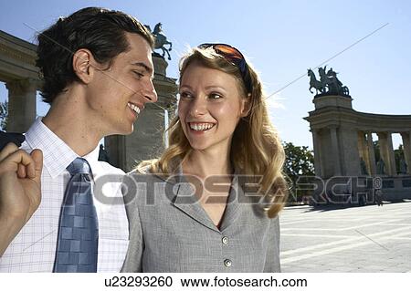 Stock Image - Businessman and businesswoman outdoors.. Fotosearch