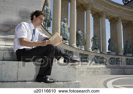 Businessman reading newspaper outdoors. View Large Photo Image Stock Image - Businessman reading newspaper outdoors.. Fotosearch