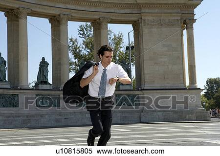 Businessman running looking at watch. View Large Photo Image Stock Photography - Businessman running looking at watch.. Fotosearch