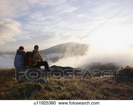 Stock Image - Couple in mountain landscape.. Fotosearch