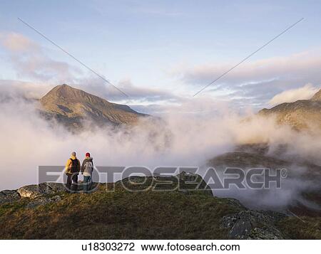 Stock Image - Couple in mountain landscape.. Fotosearch