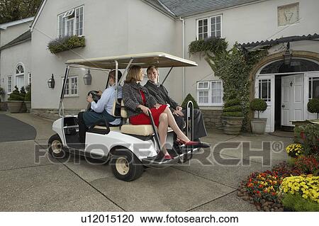 Man driving cart with man and woman. View Large Photo Image Stock Image - Man driving cart with man and woman.. Fotosearch