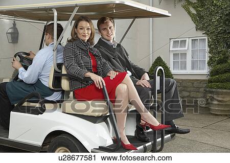 Man driving cart with man and woman. View Large Photo Image Stock Image - Man driving cart with man and woman.. Fotosearch