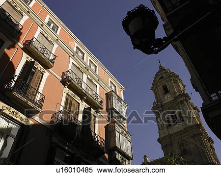 Stock Photography - Spain, Andalusia, Malaga, Old Town, clock tower and apartment balconies. Fotosearch