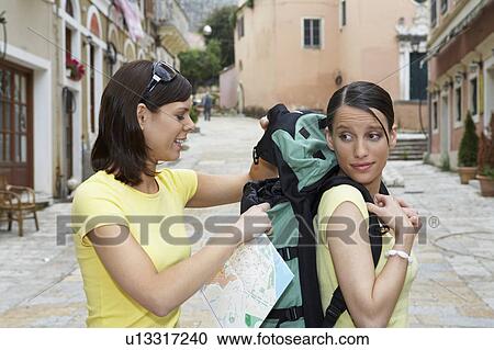 Stock Image - Two travelers in old city with map.. Fotosearch