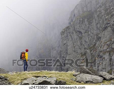 Stock Image - Woman in mountain landscape.. Fotosearch