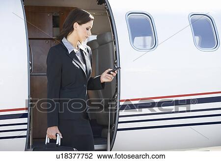 Stock Image - A business woman boarding a plane. Fotosearch