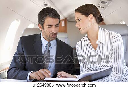 A businessman talking to his PA on a plane View Large Photo Image Stock Photography - A businessman talking to his PA on a plane. Fotosearch
