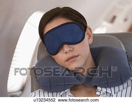 A businesswoman asleep on a flight View Large Photo Image Stock Image - A businesswoman asleep on a flight. Fotosearch
