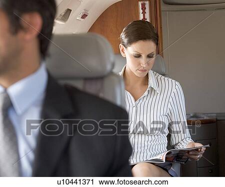 Passengers relaxing on a flight View Large Photo Image Stock Image - Passengers relaxing on a flight. Fotosearch