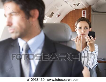 Passengers relaxing on a flight View Large Photo Image Stock Photo - Passengers relaxing on a flight. Fotosearch