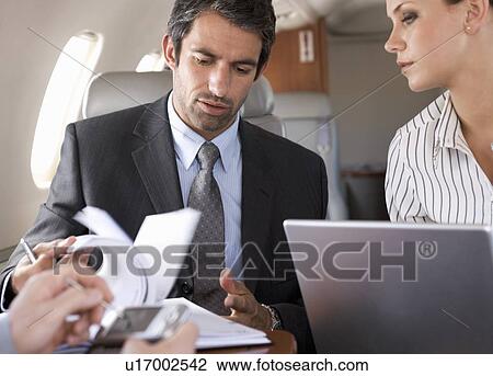 Three business colleagues working on a flight View Large Photo Image Stock Image - Three business colleagues working on a flight. Fotosearch