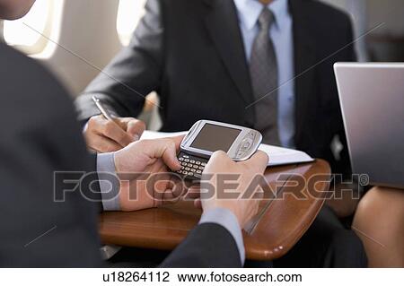 Three business colleagues working on a flight View Large Photo Image Stock Image - Three business colleagues working on a flight. Fotosearch