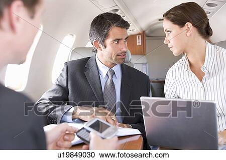 Stock Image - Three business colleagues working on a flight. Fotosearch