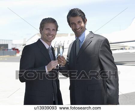 Stock Image - Two business colleagues drinking champagne. Fotosearch