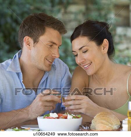 A couple eating at a restaurant View Large Photo Image Stock Photo - A couple eating at a restaurant. Fotosearch