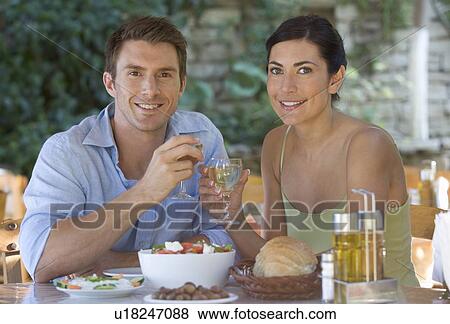 Stock Photo - A couple eating at a restaurant. Fotosearch