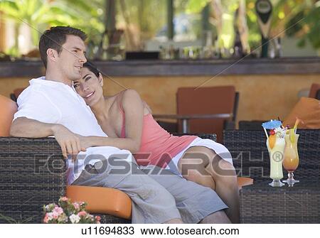 A couple relaxing with a drink View Large Photo Image Stock Image - A couple relaxing with a drink. Fotosearch