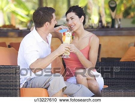 Stock Image - A couple relaxing with a drink. Fotosearch