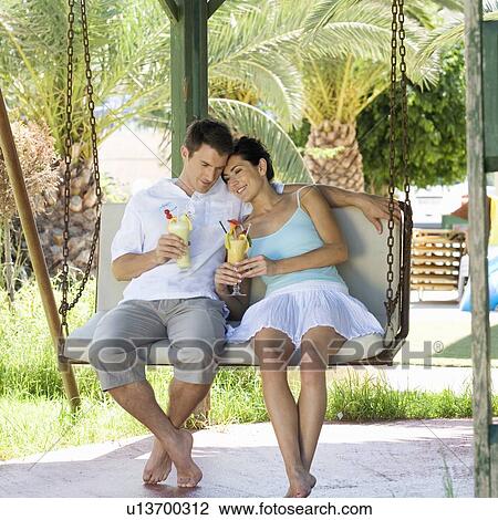 Stock Image - A couple relaxing with a drink. Fotosearch