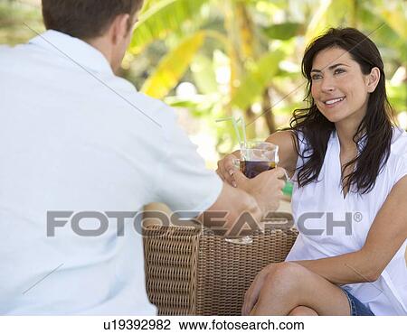 A couple relaxing with a drink View Large Photo Image Stock Image - A couple relaxing with a drink. Fotosearch