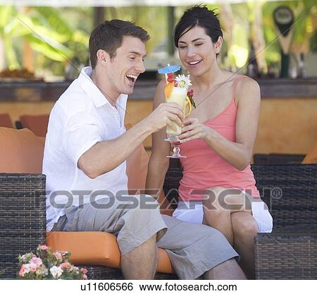Stock Photograph - A couple relaxing with a drink. Fotosearch
