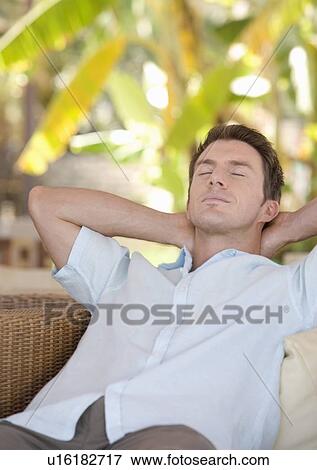 Stock Photo - A man relaxing in a chair. Fotosearch