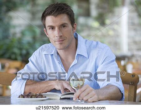 A man sitting alone in a restaurant View Large Photo Image Stock Image - A man sitting alone in a restaurant. Fotosearch