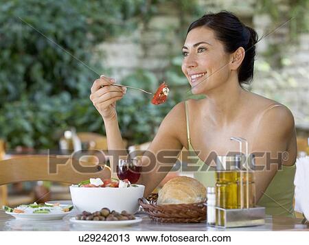 A woman eating a salad View Large Photo Image Stock Image - A woman eating a salad. Fotosearch
