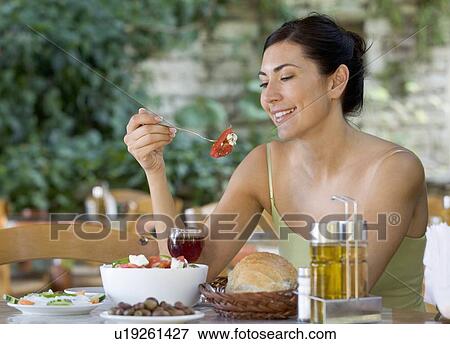 A woman eating a salad View Large Photo Image Stock Photo - A woman eating a salad. Fotosearch