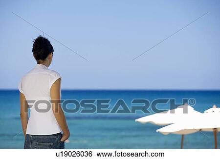 Stock Photograph - A woman relaxing on holiday. Fotosearch