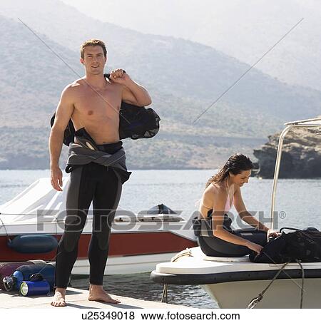 A couple going scuba diving on holiday View Large Photo Image Stock Photo - A couple going scuba diving on holiday. Fotosearch