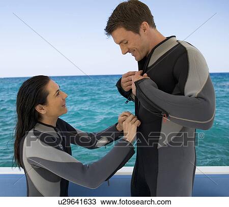 A couple on a boat preparing to go scuba diving View Large Photo Image Stock Image - A couple on a boat preparing to go scuba diving. Fotosearch