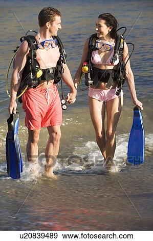A couple returning from scuba diving View Large Photo Image Stock Photo - A couple returning from scuba diving. Fotosearch