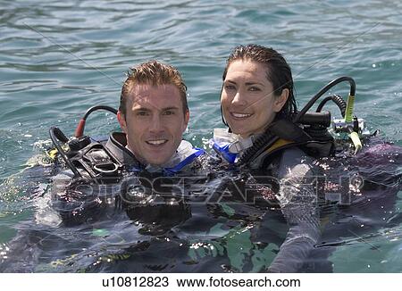 Stock Image - A couple scuba diving. Fotosearch