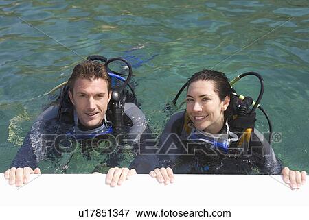 Stock Photo - A couple scuba diving. Fotosearch