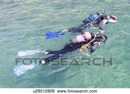 A couple scuba diving View Large Photo Image Stock Photo - A couple scuba diving. Fotosearch