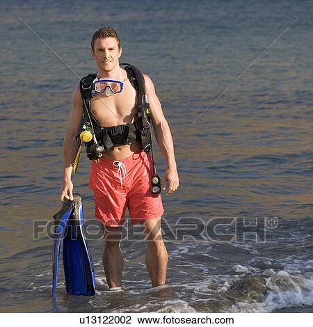 A male scuba diver returning to the shore View Large Photo Image Stock Image - A male scuba diver returning to the shore. Fotosearch