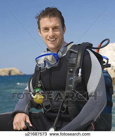 A male scuba diver sitting on a boat View Large Photo Image Stock Image - A male scuba diver sitting on a boat. Fotosearch