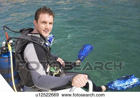 Stock Photo - A man about to go scuba diving. Fotosearch