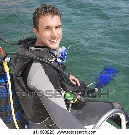 Stock Photograph - A man about to go scuba diving. Fotosearch