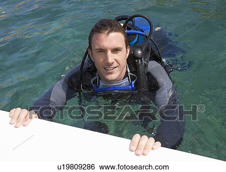 Stock Photograph - A man scuba diving. Fotosearch